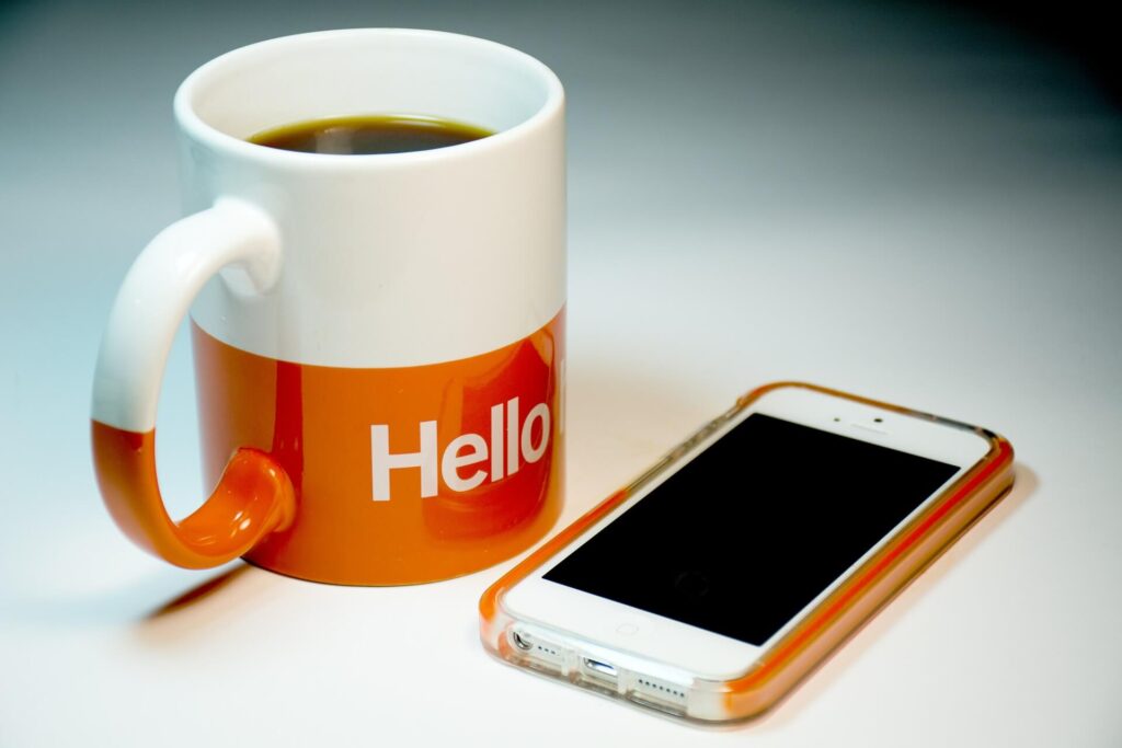 iPhone and a hello coffee mug